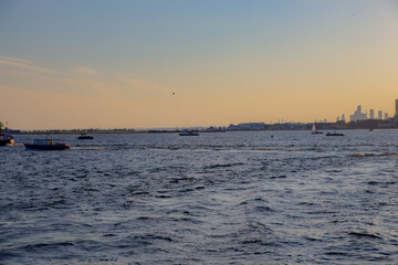 Sunset view of Toronto and water taxi in lake Ontario