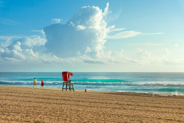 Empty beach at early morning by the Hotel Zone (Zona Hotelera) area with a lifeguard station with...