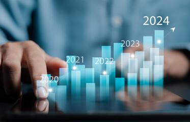 New year business goals 2024 and positive indicators 2024. Businessman analyzing economic trend data for long-term investment. Development to success and motivation.