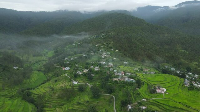 Aerial shot of a small village in the foothills of uttarakhand. Traditional kumaoni homes. 