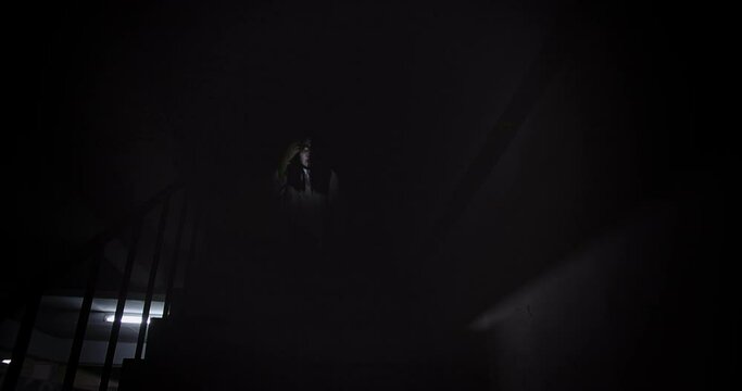 Horror scene of a mysterious Scary portrait Asian ghost woman creepy looking to camera with Flickering flash Lights sitting on staircase dark scene movie at night, holiday ghost Halloween concept