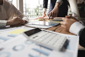 Business People Meeting to analysis the financial report paperwork on digital tablet in office. Financial advisor teamwork and accounting concept