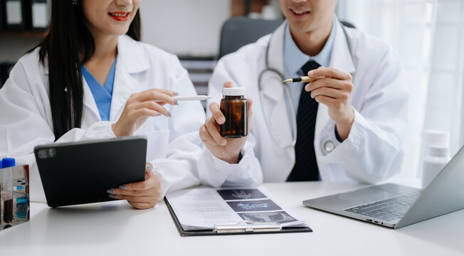 Medical technology network team meeting concept. Doctor hand working with smart phone modern digital tablet and laptop computer with graphics chart interface, with virtual icon diagram