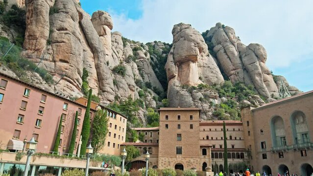 Beautiful Monastery buildings and Hotels in Montserrat mountain village town. Montserrat Monastery Resort with a green mountain gorge range near Barcelona in Catalonia, Spain.