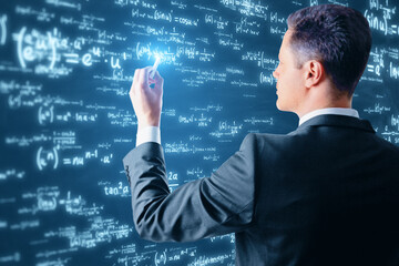 Side view of young european businessman using glowing digital math formulas hologram on blurry...