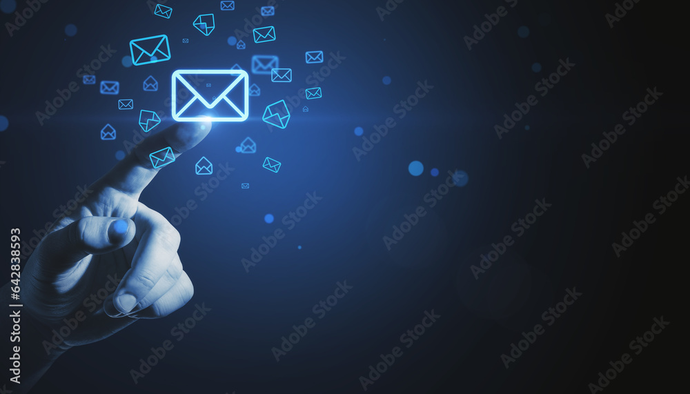 Poster close up of businessman hand pointing at glowing email letter icons on dark blue background with moc