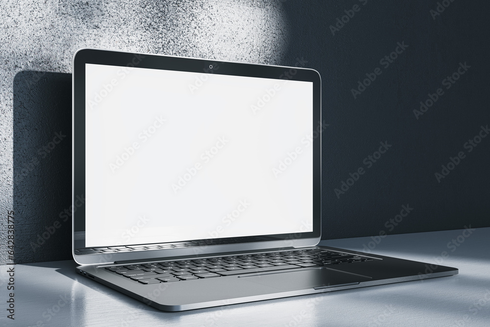 Aufkleber Close up of notebook computer with empty white mock up screen placed on desk. Concrete wall with shadows in the background. 3D Rendering.