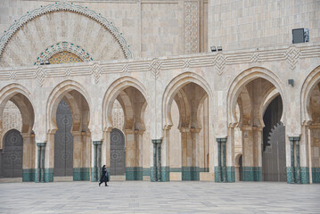 Fototapeta na wymiar Casablanca, Morocco - Feb 26, 2023: Exterior architecture of the Hassan II Mosque, the largest mosque in Africa
