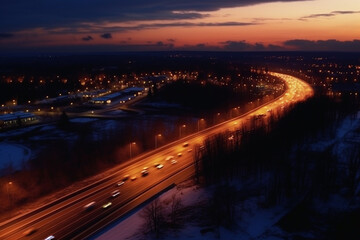 Fototapeta na wymiar Aerial view of highway and cityscape at dusk. Top view