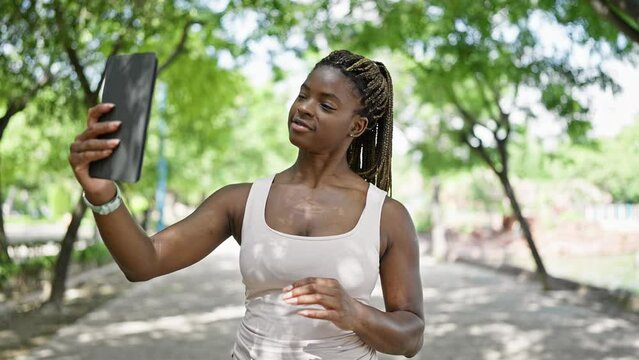 African american woman smiling confident making selfie by the touchpad at park