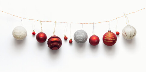 Various christmas balls on a rope on a white background top view. Creative winter holidays, New...