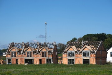 Fototapeta premium Building a house in a housing estate outside the city