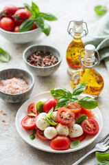 Obraz na płótnie Canvas Caprese salad with tomatoes, mozzarella and basil.