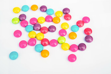 Various colored chocolate candies on a white background