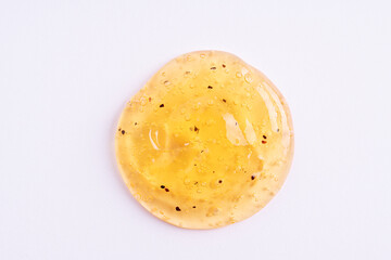 Transparent orange cosmetic sample texture with bubbles. Cosmetic peeling gel with fruits. Cosmetic scrub, beauty background.