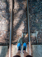 Upper view down to legs on narrow gauge railway. - 642882354