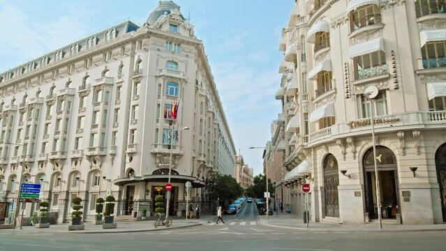 Beautiful royal-style luxury hotel boutique in the centre of Madrid in Spain. People walking on a Historical Madrid street 
