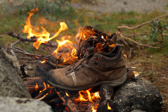 Recycling of old shoes. Old shoes are burning in the fire
