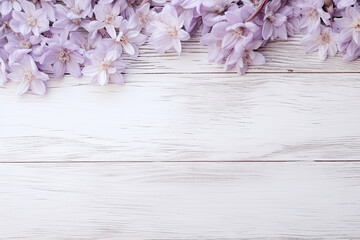Purple flowers on a white wooden background, copy space 