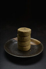 baked luxury Japanese matcha hojicha crisp tart mooncake with cranberry pineapple fruit jam with gold foil cookies dessert on dark background pastry dessert halal festive vegan food cake menu for cafe