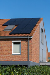 solar panels on roof of a townhouse with bricked facade