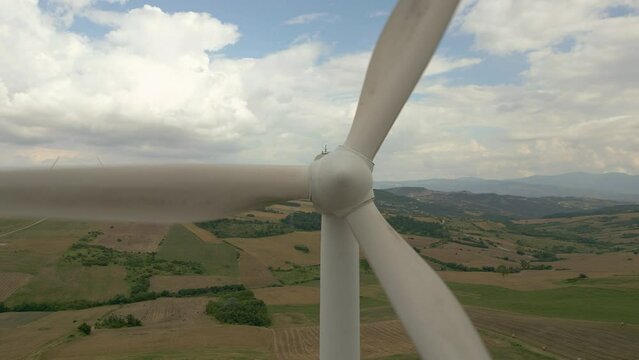 aerial view from the drone of a wind turbine farm producing renewable energy from the wind. We are in near Bisaccia in Campania Italy