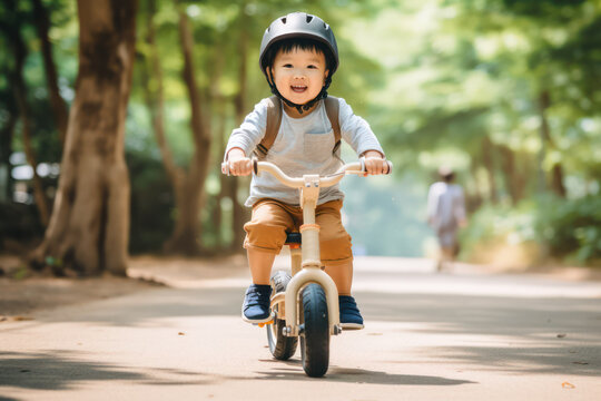 First Steps to Cycling: Asian Kid Playfully Learns to Ride with a Balance Bike - Early Cycling Adventures