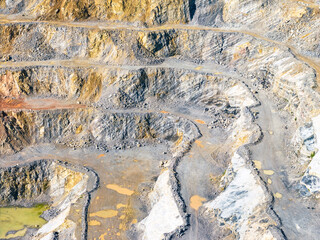 Opencast Mine Aerial View. Industrial terraces in a mining quarry. Open pit mining of dolomite. Excavation machinery of the dolomite mine. Extractive industry. Opencast mining.