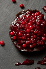 Delicious dessert with lingonberry jam on a dark background, top view