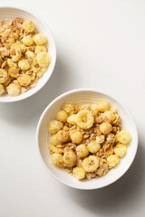 Breakfast with granola in small bowls on a white background