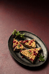 crumble with lingonberry jam on a dark tray