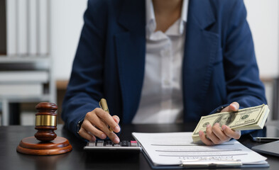 Lawyer or accounting department writes a note and uses a calculator to calculate expenses - income. at office lawyer.