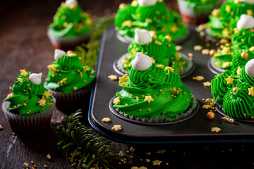 Delicious green cupcakes with sprinkles for the Christmas.