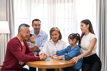 Portrait of happy love family asian father and mother playing with adorable asian baby and sister girl.newborn, infant.mom touching with cute son moments good time with grandparents.Love of big family