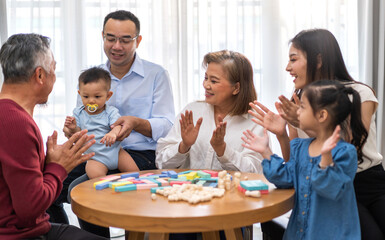 Portrait of happy love family asian father and mother playing with adorable asian baby and sister girl.newborn, infant.mom touching with cute son moments good time with grandparents.Love of big family