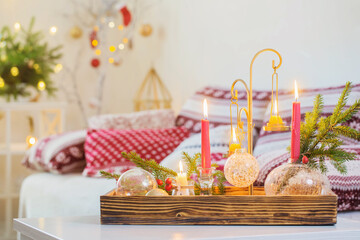 christmas home decorations with candles in red and white colors