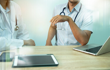 Smart medicine doctors working with computer notebook and digital tablet  at desk in the hospital. Medical concept.Medical teamwork discussion