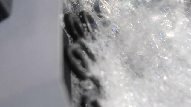 Soap bubble generator close up. Working operation Soap Bubble Generator and inflating soap bubbles. Bubble machine. Automatic blowing soap bubbles. Creating bubbles. Entertainment, celebration, party