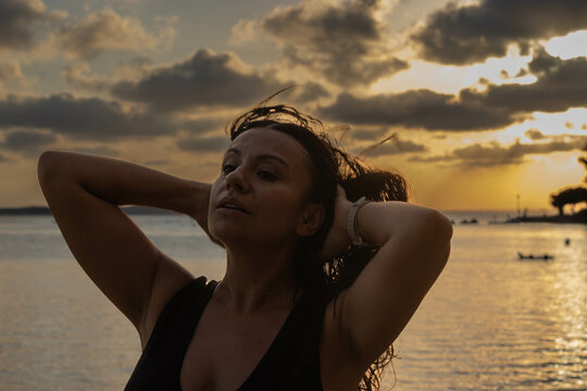 joven modelo paseando con fondo de atardecer ene l mar