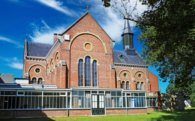Venray (Vincent van Gogh mental hospital), Netherlands - July 9. 2023: Beautiful park with church...