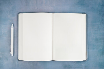 The Empty open notebook on blue old wooden table.