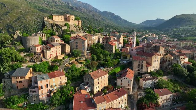 Flying over Corte old town, Corsica island, France. Morning shot of old houses on the mountain in Corte village, Corsica, France
