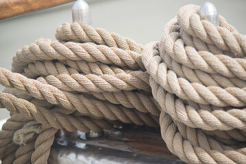 Ship's ropes are laid on the rigging of a sailboat - 642990340