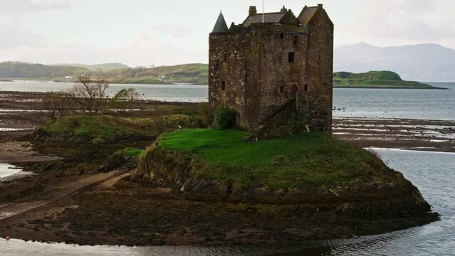 Drone up and over castle ruins in Scotland