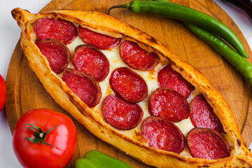 Turkish sausage pide top view on tray - obrazy, fototapety, plakaty