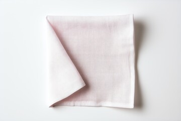 A kitchen towel folded neatly is seen white background It serves as an essential element for food serving and can also be used as a square shaped napkin when viewed from the top