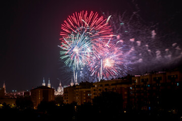 Fireworks for the celebration of the Fiestas del Pilar on the 12th of October with the Basilica del Pilar in the background illuminated by fireworks, Zaragoza, Spain.