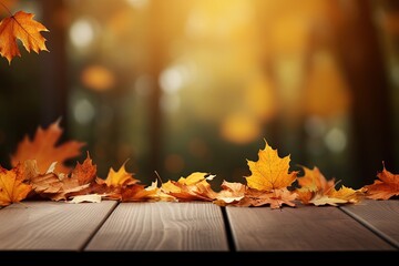 Naklejka na ściany i meble Maple leaves on table Natural autumn backdrop