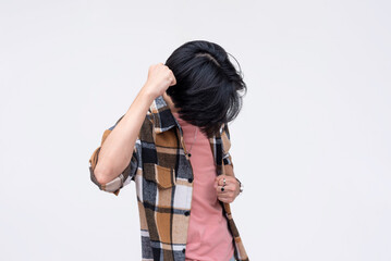 A vindicated young asian man celebrating, pumping his fist. Feeling amped and stoked. Isolated on a...