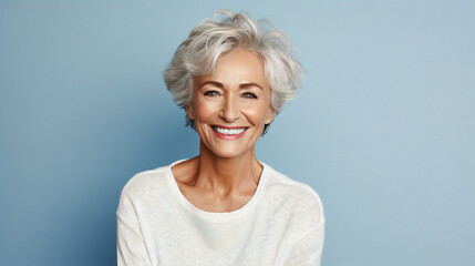 Beautiful gorgeous elderly woman 50s age senior model with grey hair laughing and smiling. Mature...
